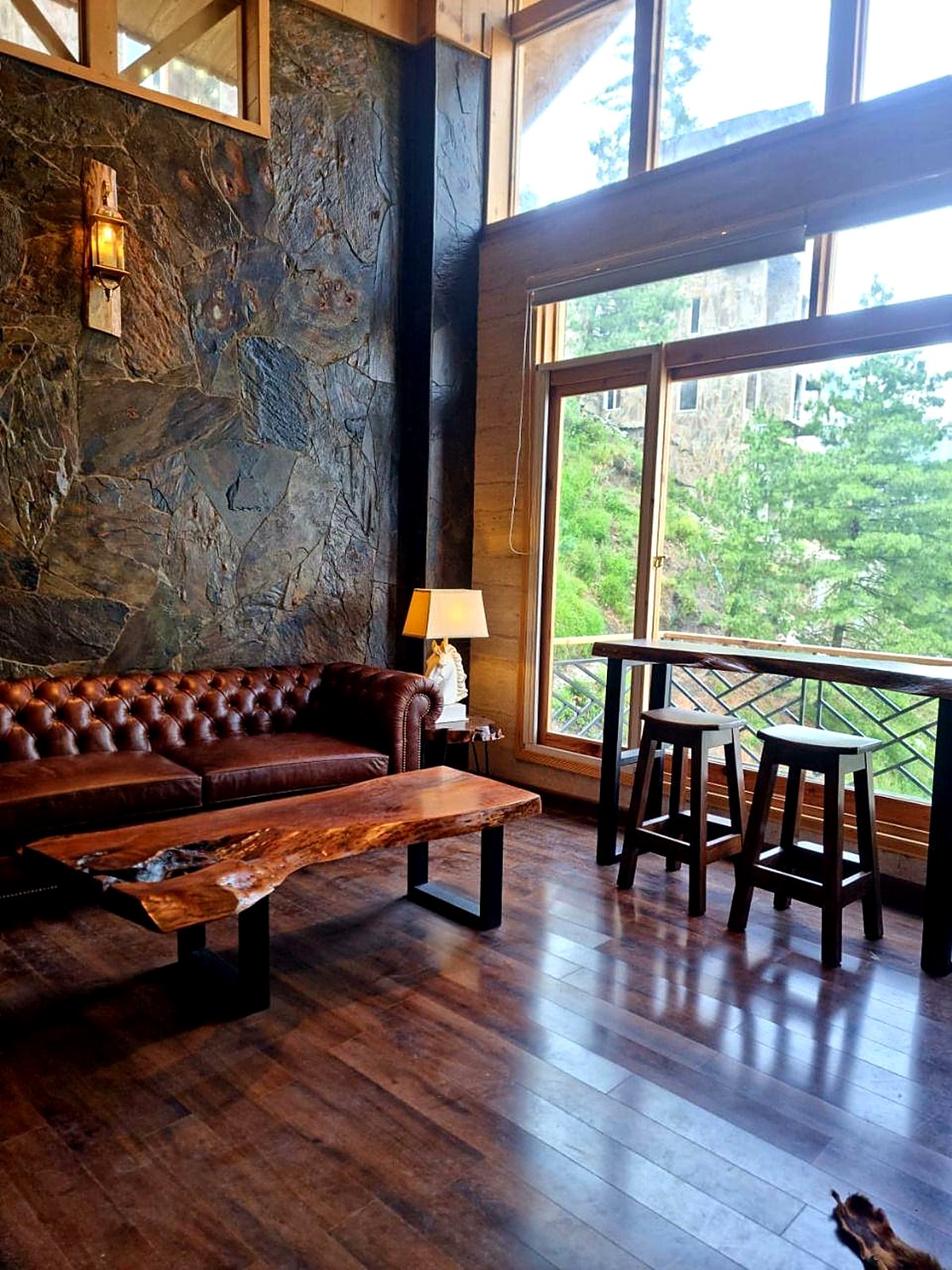 Chalet lounge with valley-facing windows at Serenity Hilltop Homes